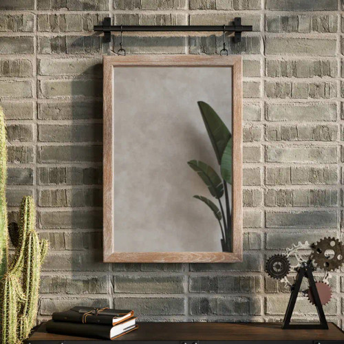 Lorae Foundry Rail Mirror, 28-inch rectangular wall featuring a natural light-wood frame suspended by black metal hooks from an industrial iron hanging bar.