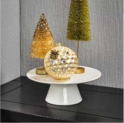A beautiful spherical holiday ornament featuring a textured, metallic gold honeycomb pattern with a realistic molded bumblebee accent on the side.