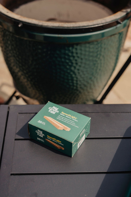 A box of Big Green Egg SpeediLight Starter Sticks showing the natural, brown compressed wood composition arranged cleanly for easy break-off use.