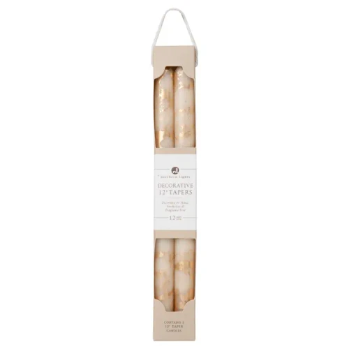 A pair of tall, elegant 12-inch taper candles featuring a smooth cream wax body accented with a shimmering metallic gold brushed finish along the lower portion. The candles stand slender and refined, ideal for traditional candlesticks or holiday centerpiece displays.