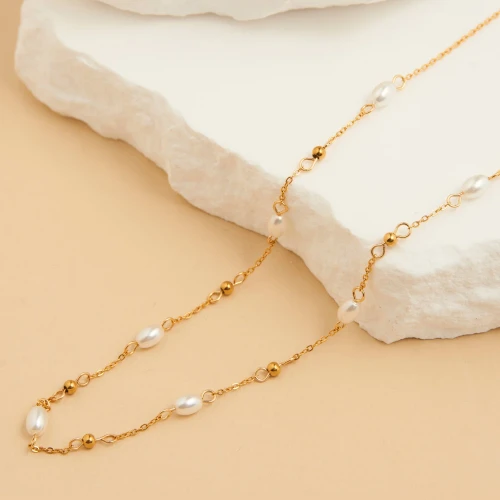 Dainty gold beaded chain featuring delicate pearls, designed to be waterproof and tarnish-resistant for everyday wear.