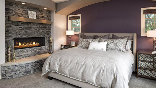 Front view of a Heat & Glo Mezzo 60-inch linear direct vent natural gas fireplace featuring a modern ribbon flame spreading across an expansive glass media bed with reflective black glass interior panels.