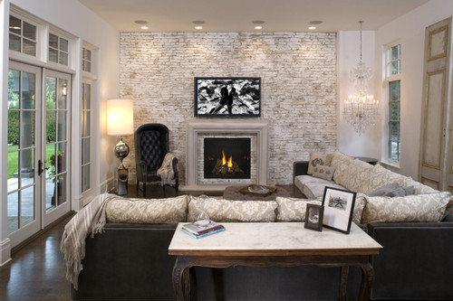 Front view of a Heat & Glo TRUE 36-inch direct vent natural gas fireplace showcasing high-definition logs and dynamic flames against a reflective black glass interior lining.