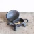 Rustic brown cast iron turtle key box with a removable shell lid, pictured outdoors in a garden setting hiding a spare door key.