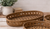 Vintage-Style Rattan Tray displayed on a rustic tabletop, featuring intricate lattice detailing and natural farmhouse styling.