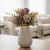 A 12-inch artificial Rose Chrysanthemum Stem featuring soft mauve blooms, eucalyptus, and muted greenery arranged in a white ceramic vase for elegant farmhouse décor.