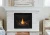 Front view of the Heat & Glo SlimLine 9X 42-inch direct vent gas fireplace showcasing its slender depth, glowing ember bed, highly detailed ceramic Birch logs, and mirror-like reflective black glass interior panels.