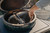 Two nesting semi-circular 304 stainless steel drip trays with overlapping lips, designed to fit an Extra Large Big Green Egg.