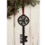 A vintage-style black wooden key decoration with a rustic weathered finish. The key features an intricate carved snowflake at the bow and the word "believe" carved along the shank. Attached at the top is a red and white gingham fabric ribbon loop for hanging on a doorknob, wreath, or Christmas tree