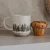 Cream-colored 14 oz forest stoneware coffee mug featuring a two-tone wraparound tree pattern in a rustic, nature-inspired design.