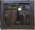 Clearance Custom Glass Fireplace Door (CL120) featuring a bold Matte Black frame with elegant Arch Window Bar Iron detailing over clear glass cabinet doors.