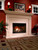 Front view of an open-hearth Heat & Glo Reveal 36-inch B-vent natural gas fireplace featuring a realistic textured log set, radiant yellow flames, and a classic traditional brick refractory lining.