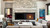 Front view of a Heat & Glo TRUE 36-inch direct vent natural gas fireplace showcasing high-definition logs and dynamic flames against a traditional Stratford brick interior lining.