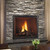 Front view of a Heat & Glo TRUE 36-inch direct vent natural gas fireplace showcasing high-definition logs and dynamic flames against a Tranquil Greige Herringbone brick interior lining.