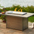 The  Brooks Rectangular Gas Fire Pit Table in Taupe featuring a modern composite decking top and base with a Graphite Grey aluminum frame.