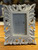 Distressed White Carved Scroll Frame - II