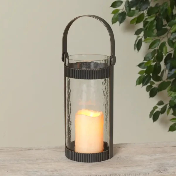 A modern and elegant house-shaped clear glass lantern with a minimalist frame, beautifully showcasing a glowing candle inside to create a warm, inviting ambiance for indoor or outdoor spaces.