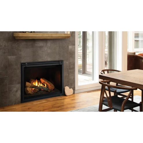 Front view of the Heat & Glo 6KX 36-inch direct vent gas fireplace showcasing its vibrant flame display, highly detailed realistic Driftwood log set, and a traditional Large Tranquil Greige refractory brick interior lining.