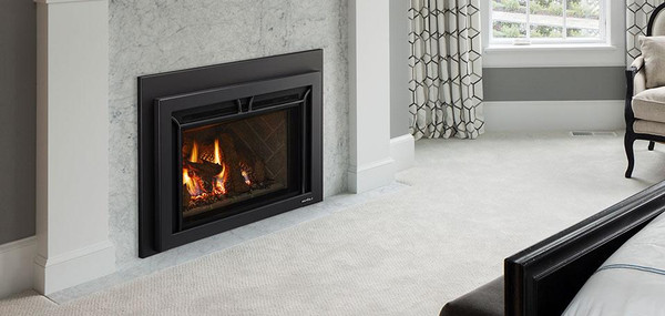Front view of the Heat & Glo SupremeX Large 35-inch direct vent natural gas fireplace insert showing a wide, immersive firebox with realistic glowing logs and premium flame presentation.