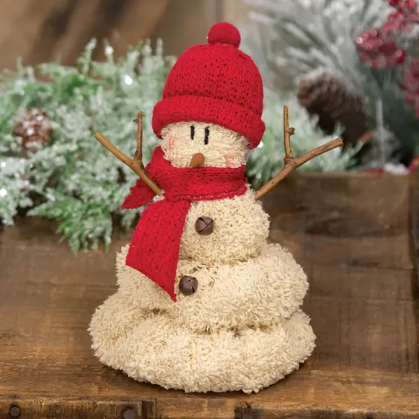 A soft plush snowman decorative figurine designed in a playful melting puddle style. It features a plush white body with dark coal button accents, an orange carrot nose, and a cozy red knit winter hat with a plush brim and festive trim.