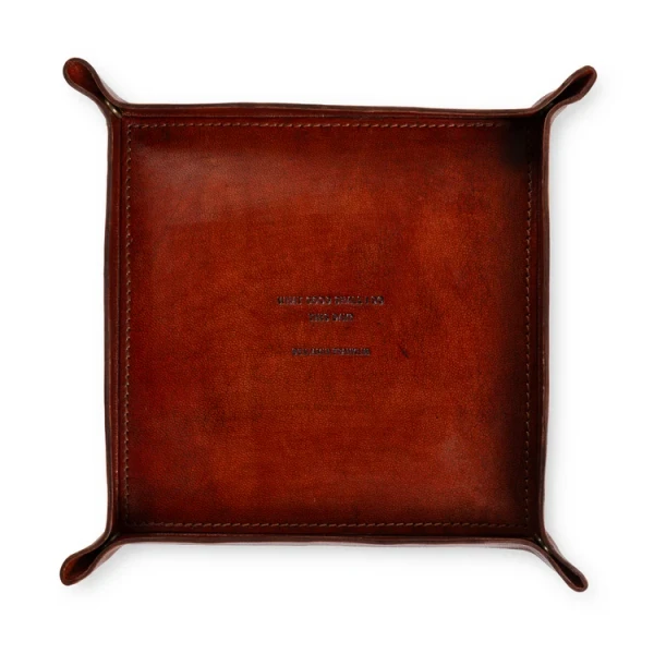 Square brown leather valet tray stamped with the Benjamin Franklin quote "What Good Shall I Do This Day?"