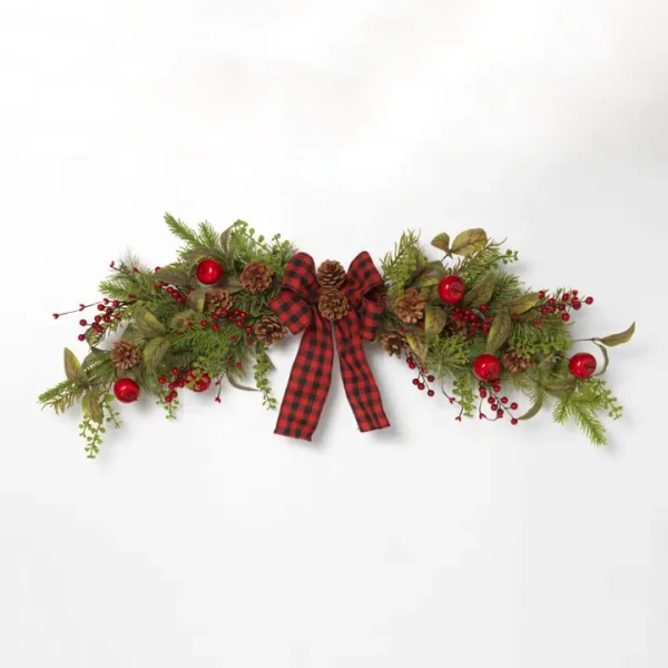 Lush artificial Christmas pine swag adorned with realistic red berries and natural pinecones for holiday door or mantel decor.
