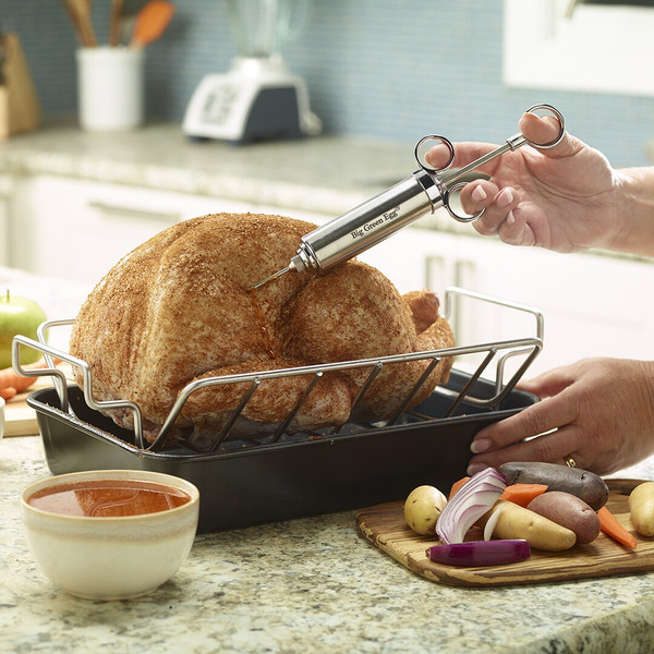 A professional-grade stainless steel meat injector with a t-shape handle plunger, shown alongside its two specialized interchangeable needles on a clean background.