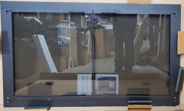 Clearance Custom Glass Fireplace Door (CL134) showcasing a clean-lined, minimalist Matte Black frame with twin clear glass cabinet doors.