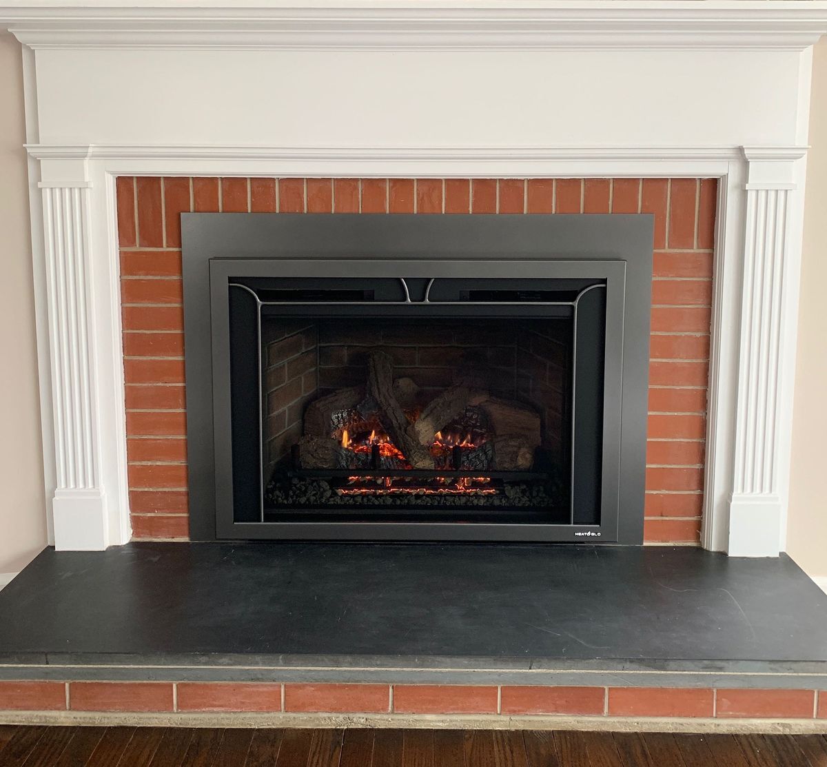 Heat & Glo Escape 35 gas fireplace insert installed in a brick masonry fireplace in a Connecticut home