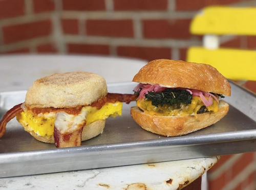 Two sandwiches on a metal tray