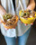 Person holding two smoothie bowls