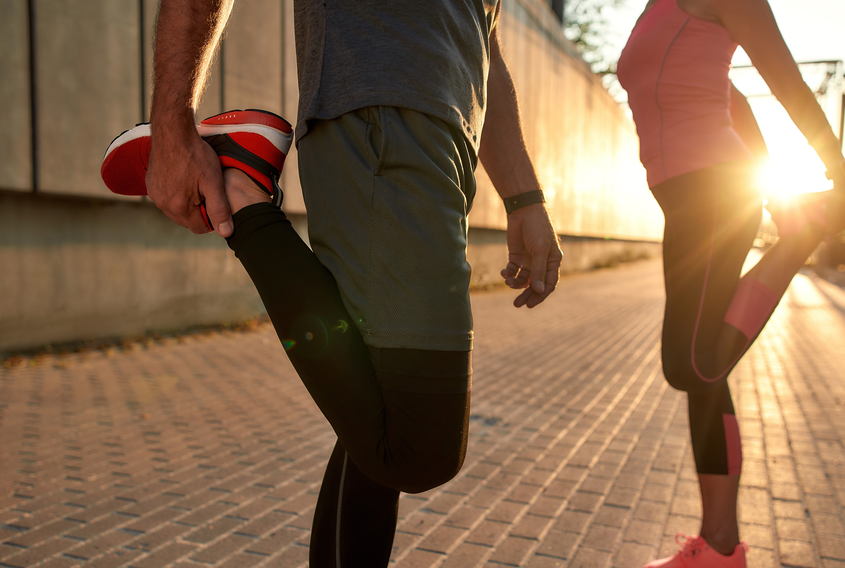 fit couple stretching before a run