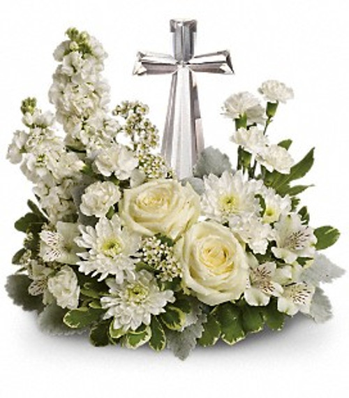 A crystal cross surrounded by white flowers