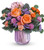 An instant spring celebration! Gorgeous orange and peach flowers are simply stunning in this iridescent lavender glass vase.
