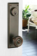 Emtek 8980 Quincy keyed sideplate lockset with knob installed on a white door in Oil Rubbed Bronze finish, lifestyle in-use view