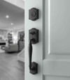 Baldwin Reserve Westcliff Single Cylinder Handleset in Satin Black installed on a white entry door, lifestyle view showing interior living space