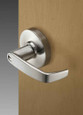 Sargent 10XG24 cylindrical lock installed on wood door – L Lever on L Rose, satin finish, showing keyway and lever profile from exterior side