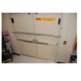 Exit Security Double Door Outswing Door Bar installed on double outswing exit doors in a commercial retail setting
