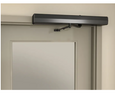 Norton Rixson 5200 Series Low Energy Power Operator installed above a door, 690 Dark Bronze finish, double lever arm push-side configuration, interior corridor setting