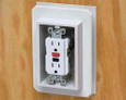 Arlington Industries FS8091F Weatherproof Siding Device Outlet Box shown installed with GFCI duplex outlet, interior installation view