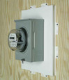 Arlington Industries Meter Mounting Base installed on wood siding with meter socket and utility meter - showing 1-inch overhang flush-mount installation