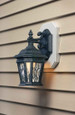 Arlington Industries Siding Mounting Kit installed on tan lap siding with black ornate outdoor lantern – finished installation view