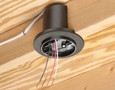 Arlington Industries L-Shaped Fan Box — completed rough-in view with wires routed and box flange seated flush against ceiling drywall, joist visible above