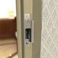 HES 8500 Universal Electric Strike Body installed in metal door frame, field application view