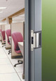 HES 1006 Series Electric Strike installed in commercial office door frame, shown from corridor side