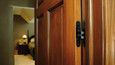 SOSS 216 Series 4-5/8" invisible hinge installed on interior wood door, shown in closed position with hinge fully concealed from door face