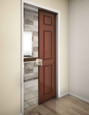 Trimco 1069FP ADA pocket door pull installed on a wood pocket door leading to a bathroom, showing real-world application and scale