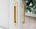 Emtek Modern Rectangular Flush Pull in Satin Brass (US4) installed on a door, shown as the opposite-side flush pull paired with a door pull