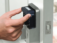 Close-up in-use shot of Emtek EMPowered 2 biometric or keypad entry being operated by hand — replace with correct product image