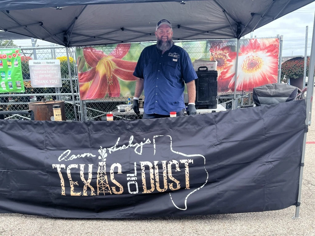Aaron Lesley cooking at a Texas Oil Dust demo tent